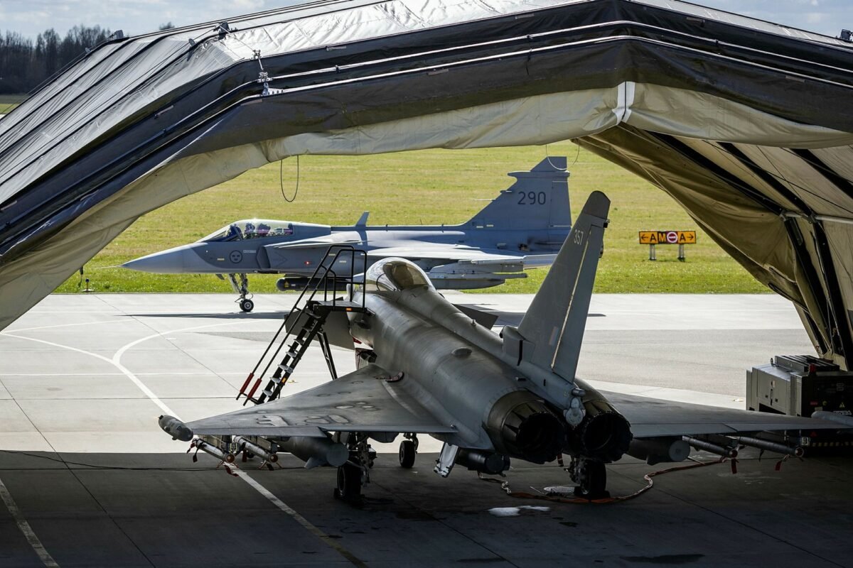 A Swedish Air Force Gripen and a Royal Air Force Typhoon, parked in a deployable shelter, train together in Poland, April 2025.