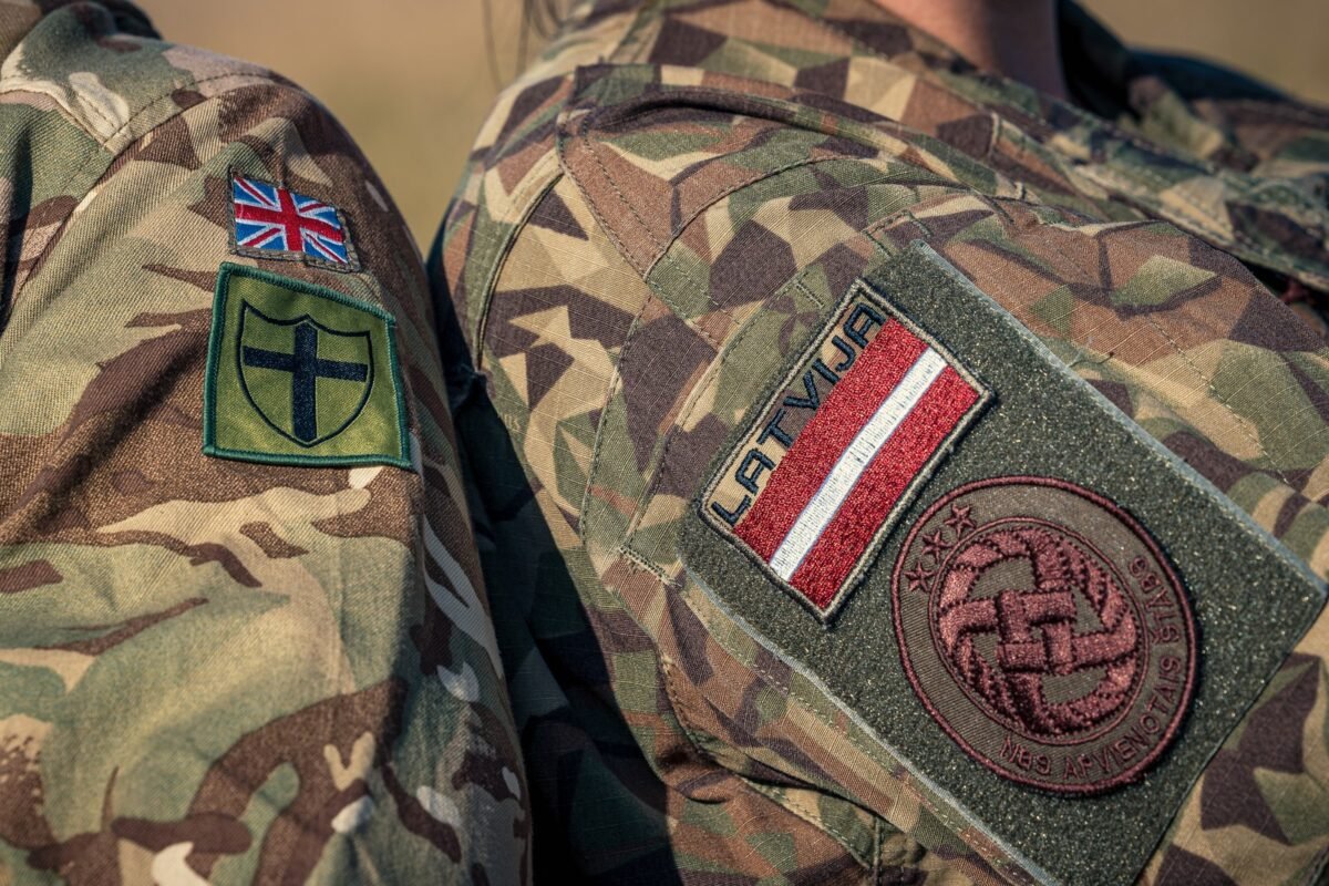 British and Latvian national flag patches side by side at Vaiņode airfield, Latvia, during exercise TARASSIS, October 7, 2025.